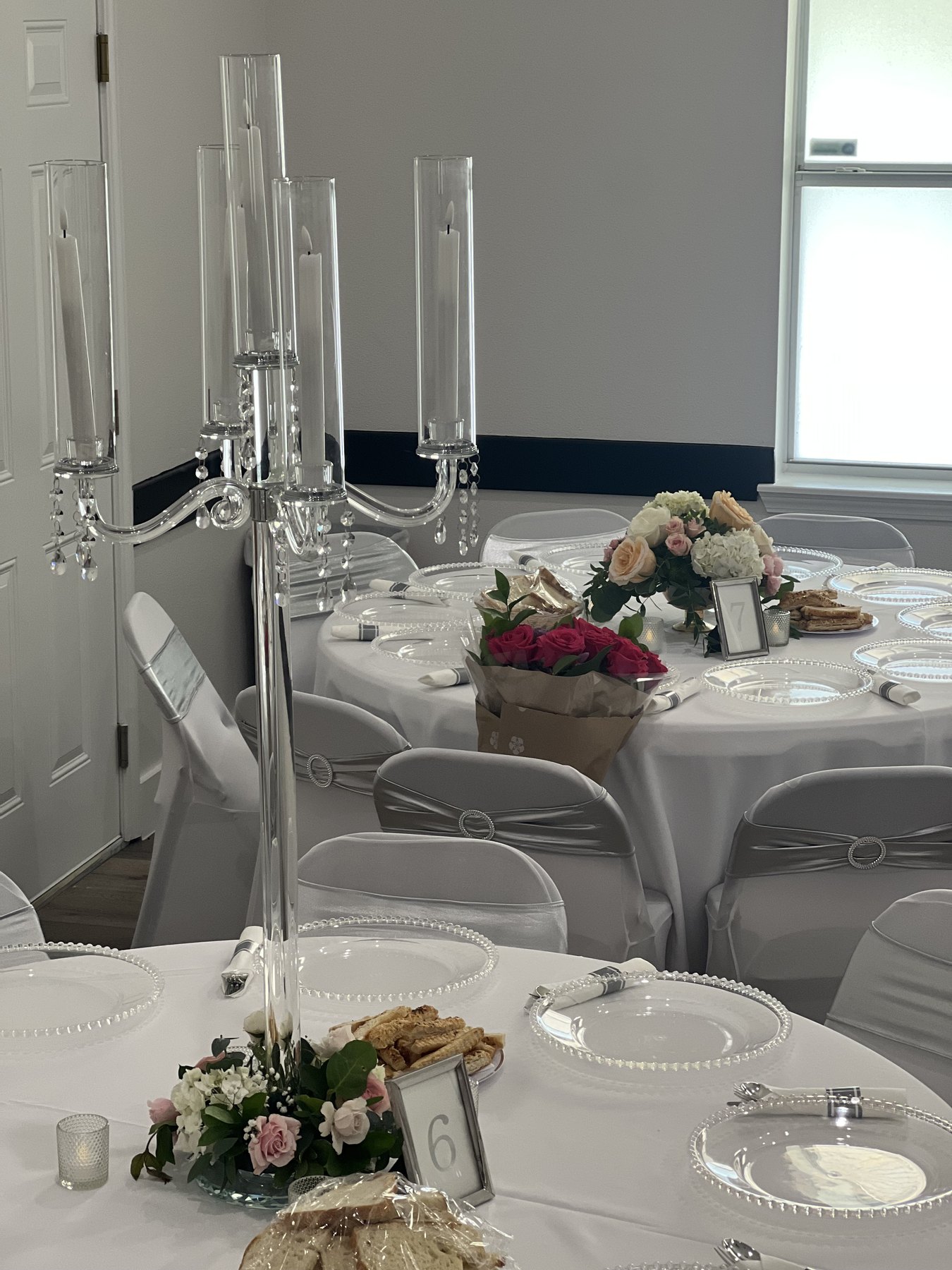 White room setup with floral accents and table settings
