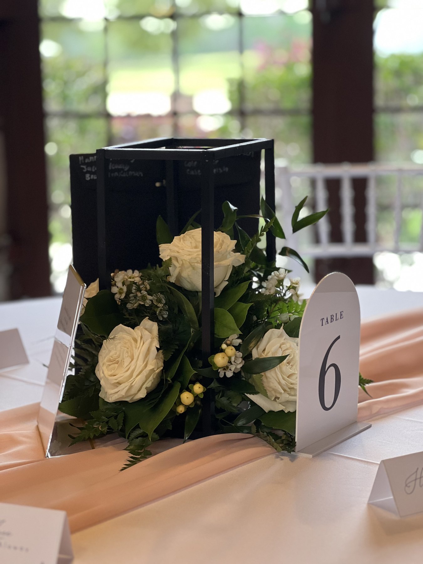 Floral centerpiece with table number and black lantern accent